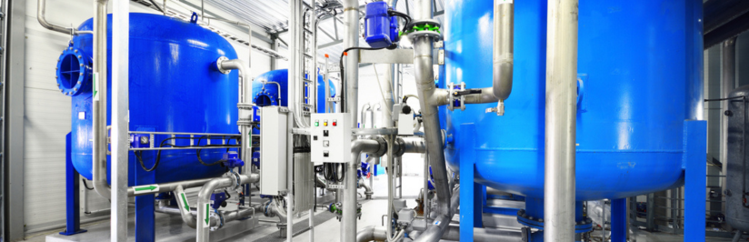 Large blue tanks in a industrial city water treatment boiler room.